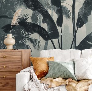 A zoomed-in of Inked jungle wallpaper behind a white sofa with textured cushions and natural wood furniture