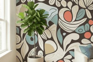 A zoomed-in of of abstract botanical mural with curved leaves and retro color accents styled beside a potted fiddle leaf fig.