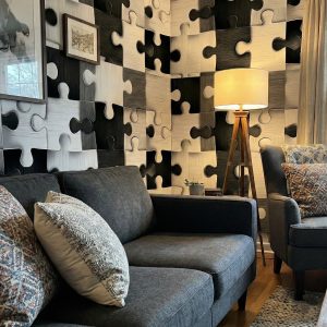 This is a zoomed in a view of black and white jigsaw puzzle pattern wallpaper with raised texture and matte finish.