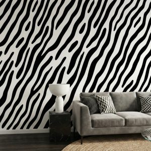 A zoomed-in of zebra wave wallpaper behind a grey sofa in a modern minimalist living room.