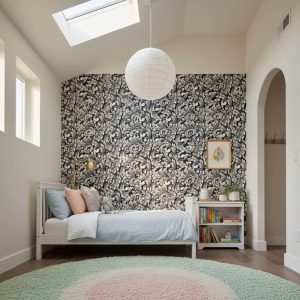 Corsica Inverse damask wallpaper in white scrollwork against black background across a dining room feature wall — Wallpaper Online South Africa