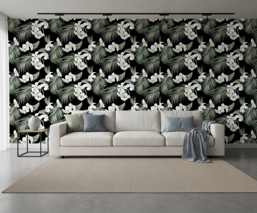 Itobah Odar floral wallpaper with white orchids and sage green foliage on black ground across a bedroom feature wall — Wallpaper Online South Africa