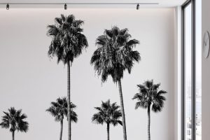 A zoomed-in of black and white palm trees with slender trunks and textured fronds creating a modern tropical mural design.