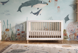 A zoomed-in of a watercolor ocean mural with whales, fish, coral, and jellyfish in soft blue tones