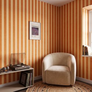 Striped wallpaper in a cozy reading corner.