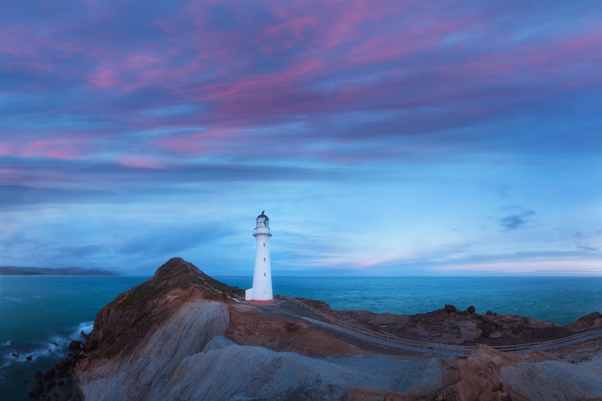 Mural Lighthouse 2 Wallpaper and Wall Murals South Africa Mural Lighthouse, lighthouse on a headland in blue and pink mural - WallpaperOnline